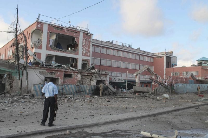 Security officers stand in front of the Sahafi Hotel in the Somali capital of Mogadishu on November 1, 2015, after a car bomb exploded. Attackers then stormed the hotel, exchanging gunfire with security guards. Al Shabab, a group linked to Al Qaeda, claimed responsibility for the attack. Said Yusuf Warsame / EPA