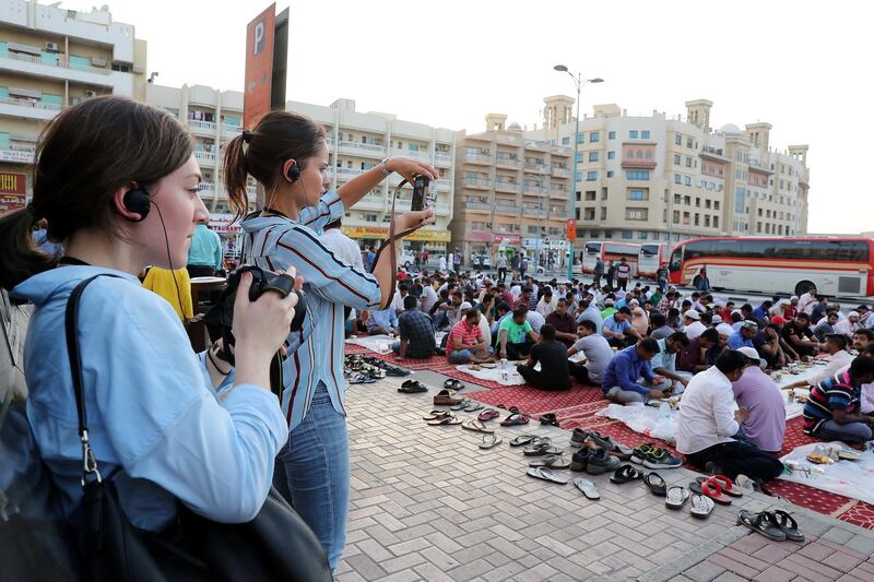 DUBAI , UNITED ARAB EMIRATES , MAY 23 – 2018 :- Participants taking photos during the iftar at the mosque near Al Ghubaiba bus station during the Unseen Trails Iftar Walk presented by Gulf Photo Plus and Frying Pan Adventures in Bur Dubai area in Dubai.  ( Pawan Singh / The National )  For Weekender
