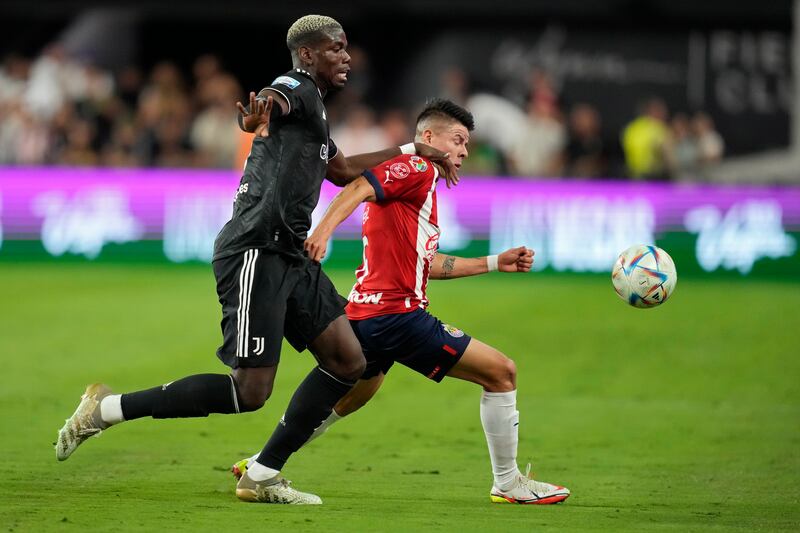 Juventus' Paul Pogba, left, and Chivas' Pavel Perez battle for the ball during their friendly in Las Vegas on Friday, July 22, 2022. AP