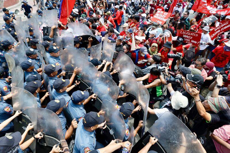 Police block protesters from marching towards the American embassy during a rally in Manila against joint exercises by the Philippines and the US in the South China Sea. EPA