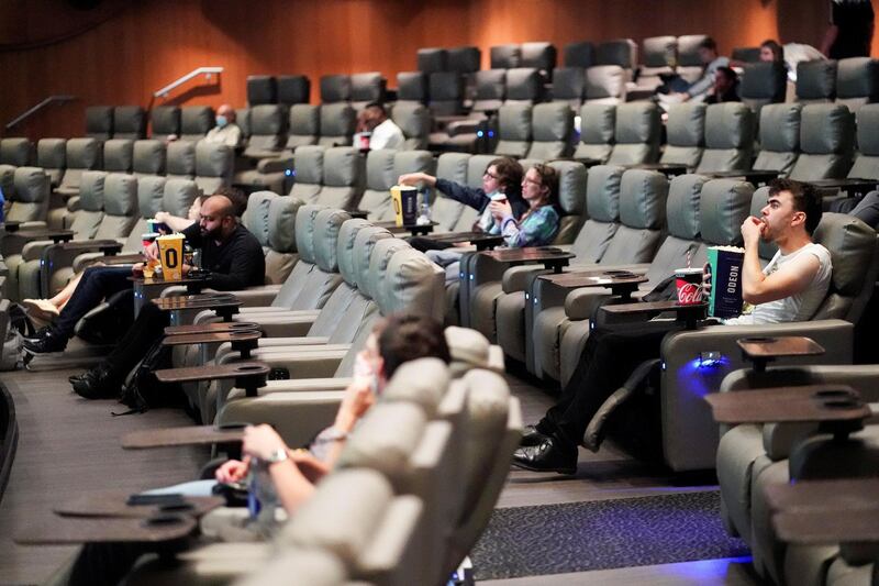 FILE PHOTO: People take their seats inside the Odeon Luxe Leicester Square cinema, on the opening day of the film "Tenet", amid the coronavirus disease (COVID-19) outbreak, in London, Britain, August 26, 2020. REUTERS/Henry Nicholls/File Photo