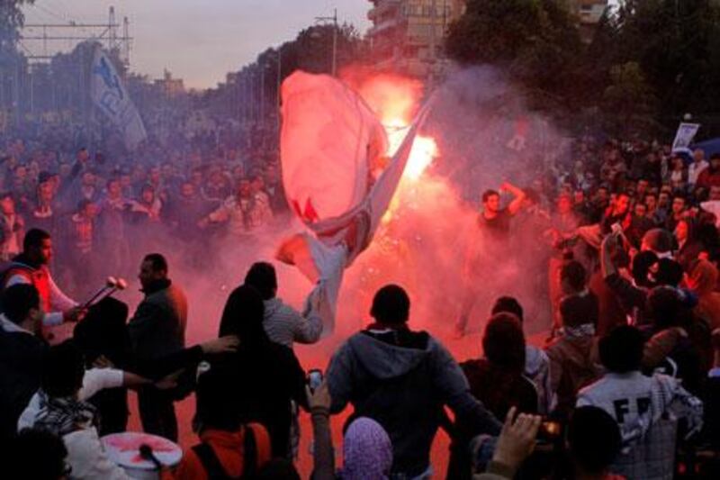 Egyptian protesters shout anti-Mohammed Morsi slogans before clashes in front of the presidential palace in Cairo on Friday. Amr Nabil / AP Photo