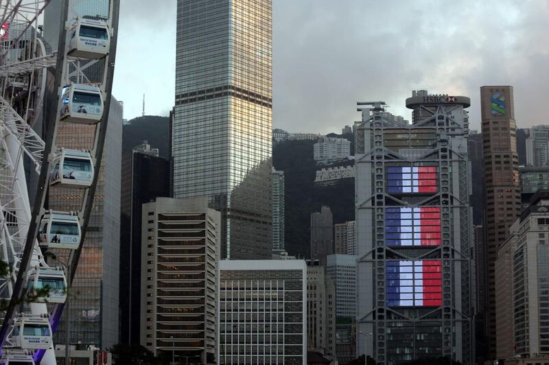 The Hong Kong and Shanghai Banking Corporation (HSBC) building shows the blue, white and red colours of the French national flag in Hong Kong on November 16, 2015. Isaac Lawrence / Agence France-Presse