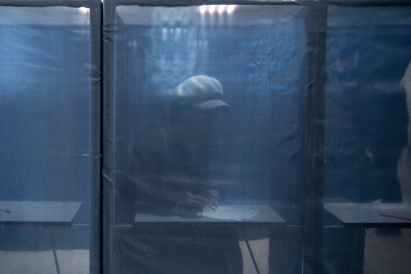A woman fills in a ballot paper at a polling station in the Russian-controlled Donetsk region of eastern Ukraine. AP