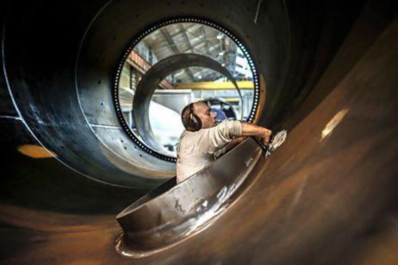 An employee works on a wind turbine tower at the FrancEole wind turbines factory in Le Creusot. Jeff Pachoud / AFP