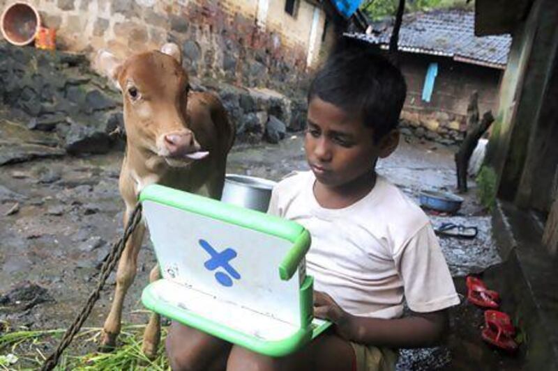 Harish, 11, uses a laptop provided under the One Laptop Per Child project in Khairat village, near Mumbai. Danish Siddiqui / Reuters