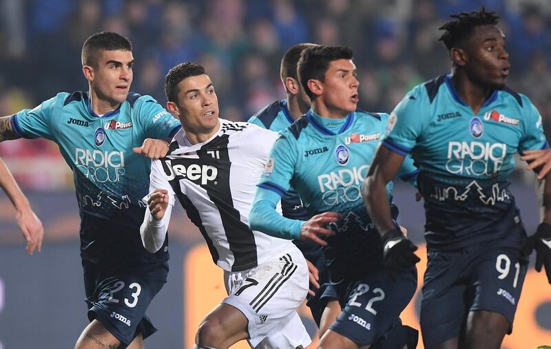 Juventus' Cristiano Ronaldo in action with Atalanta's Gianluca Mancini and Matteo Pessina REUTERS