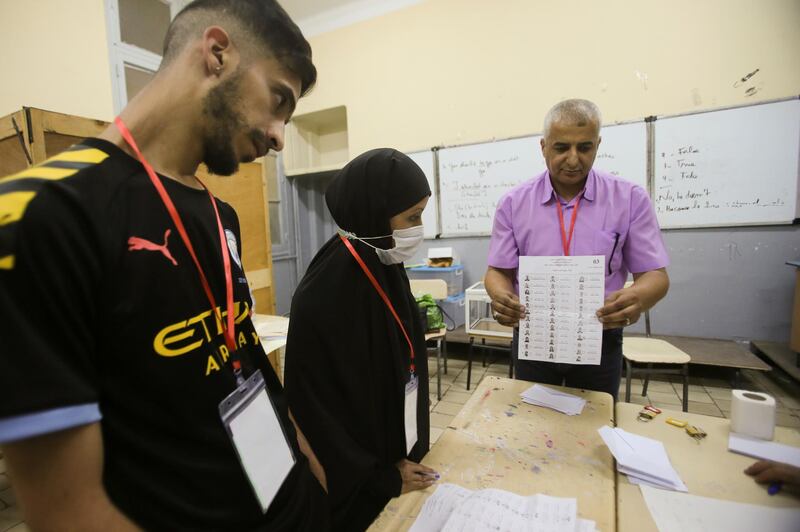 Election workers count ballots at the end of voting in the parliamentary election in Algiers. Reuters