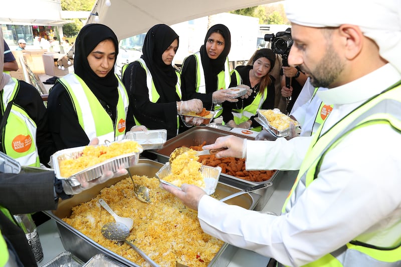 Iftar meals are served up and distributed to workers in Dubai.
Pawan Singh / The National