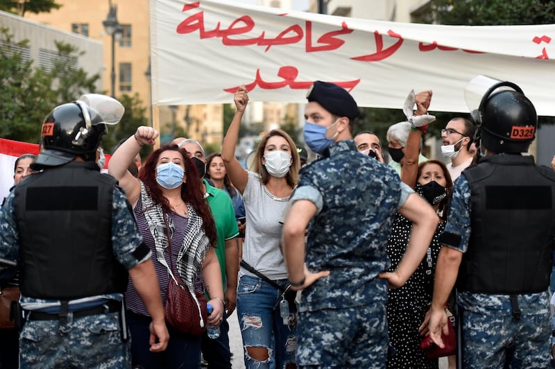 Anti-government protesters shout slogans during a protest against former Prime Minister Saad Hariri in downtown Beirut. EPA