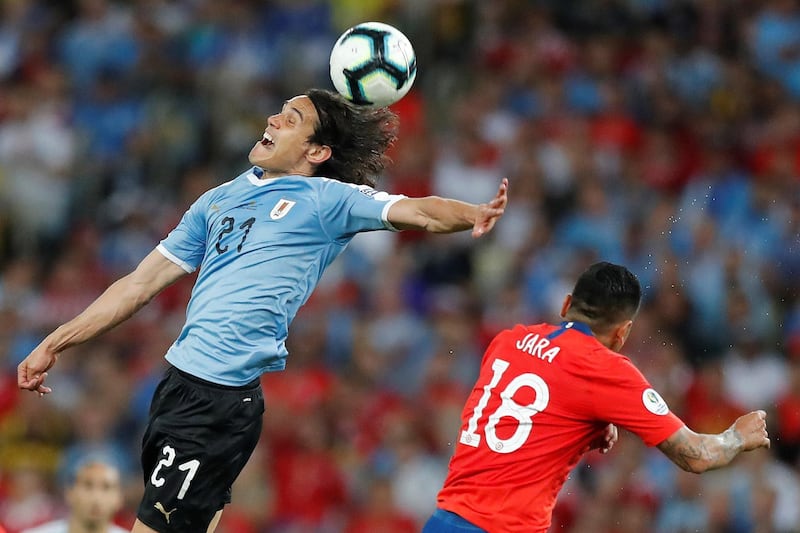 Edinson Cavani of Uruguay in action against Jara of Chile. EPA