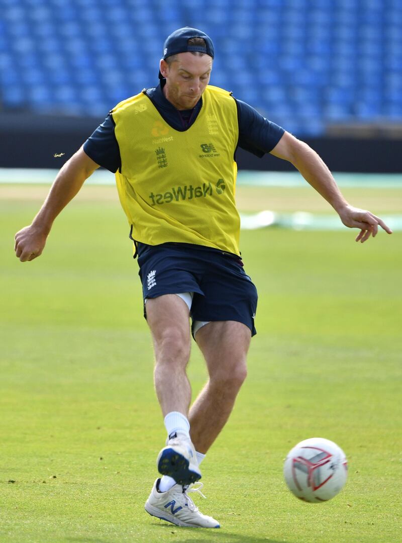 England's Jos Buttler kicks the ball. AFP