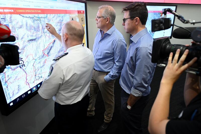 Australian Prime Minister Scott Morrison listens to New South Wales Rural Fire Service Commissioner Shane Fitzsimmons during a tour of the NSW RFS control room in Sydney, Australia, 22 December 2019. EPA