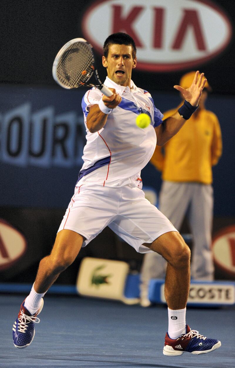 Novak Djokovic of Serbia returns against Roger Federer of Switzerland in their semi-final men's singles match on the eleventh day of the Australian Open tennis tournament in Melbourne on January 27, 2011.  Djokovic won the match 7-6, 7-5, 6-4.  IMAGE STRICTLY RESTRICTED TO EDITORIAL USE – STRICTLY NO COMMERCIAL USE   AFP PHOTO / GREG WOOD (Photo by GREG WOOD / AFP)