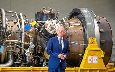 German Chancellor Olaf Scholz stands in front of a turbine of the Nord Stream 1 pipeline in Muelheim an der Ruhr, western Germany. AFP