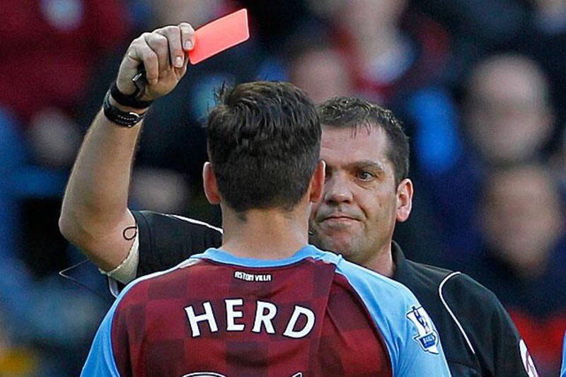 Phil Dowd, the referee for Aston Villa's 2-1 defeat to West Brom, shows Chris Herd, the Villa midfielder, a red card for his tangle with Jonas Olsson. 

Ian Kington / AFP