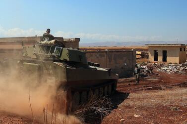 A Syrian government tank advances near the town of Khan Shaykhun in rebel-held Idlib province, Syria. AFP