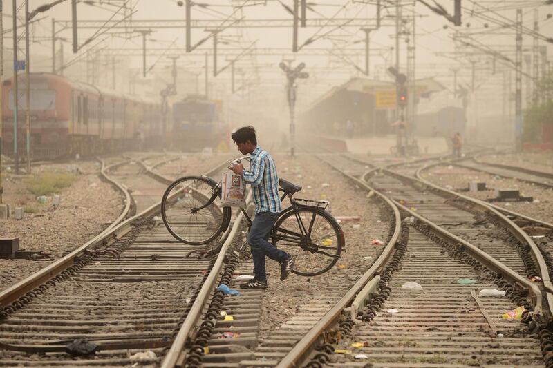 An Indian commuter crosses railway lines  in Jalandhar, India. Shammi Mehra / AFP