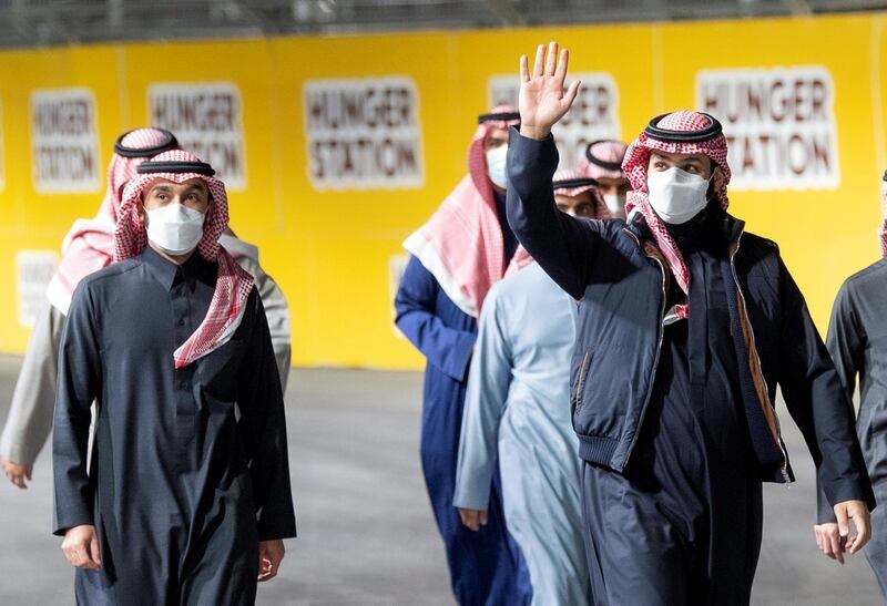 Saudi Crown Prince Mohammed Bin Salman waves as he arrives at Diriyah E-Prix 2021 in Riyadh, Saudi Arabia. Courtesy of Saudi Royal Court