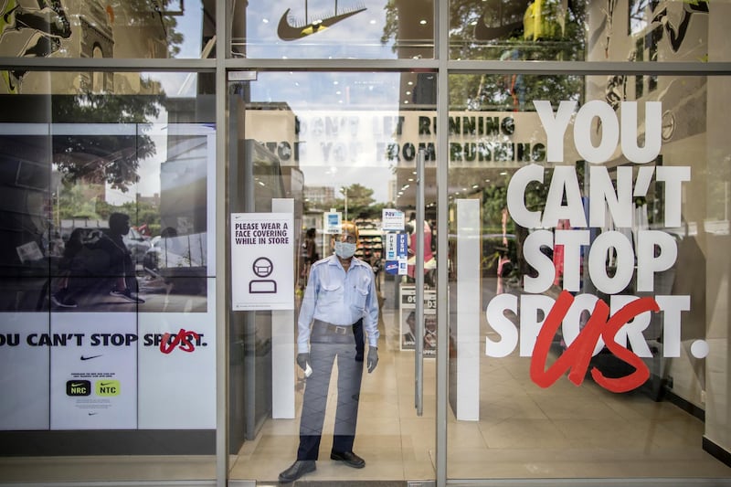 A guard stands at a store entrance in New Delhi, India. Bloomberg