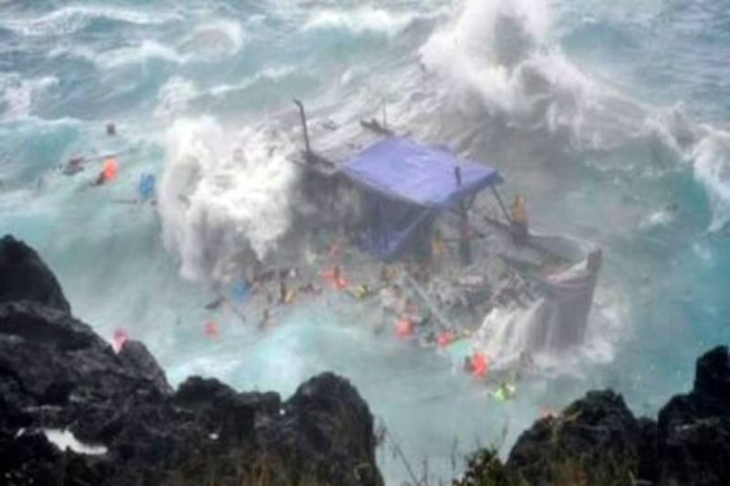 A boat laden with refugees is driven onto rocks at Christmas Island in this still image taken from video December 15, 2010. Twenty-seven asylum seekers have died and dozens may be missing after heavy waves smashed their timber boat onto rocks on Christmas Island in the Indian  Ocean off Australia on Wednesday, sinking the boat and  throwing people into stormy seas.    REUTERS/Network 7 via Reuters TV (AUSTRALIA - Tags: DISASTER IMAGES OF THE DAY) NO SALES. NO ARCHIVES. FOR EDITORIAL USE ONLY. NOT FOR SALE FOR MARKETING OR ADVERTISING CAMPAIGNS. NO ONLINE USE. NOT FOR SALE FOR INTERNET DISPLAY.  AUSTRALIA OUT. NO COMMERCIAL OR EDITORIAL SALES IN AUSTRALIA.

TEMPLATE OUT *** Local Caption ***  SIN30_AUSTRALIA-ASY_1215_11.JPG