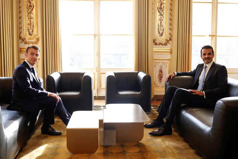 Mr Macron and Sheikh Tamim sit down for talks. Reuters