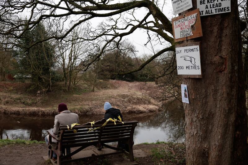 People sit on the bench where the phone was found. Her dog was found running loose on the day she vanished. Getty Images
