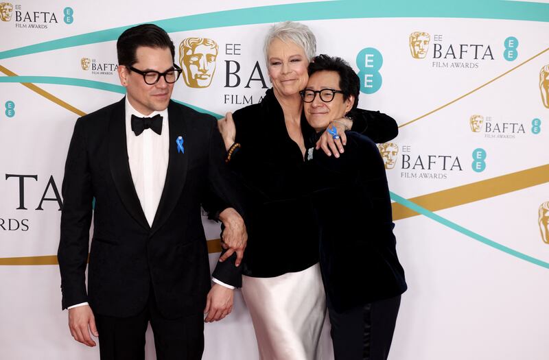 Producer Jonathan Wang, actress Jamie Lee Curtis and actor Ke Huy Quan show #WithRefugees blue ribbon support at the Baftas. Reuters