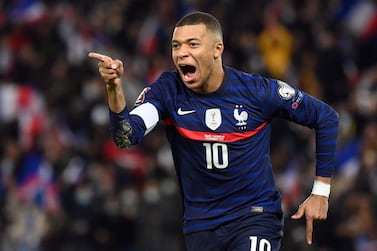 (FILES) In this file photo taken on November 13, 2021 France's forward Kylian Mbappe celebrates after scoring a goal during the FIFA World Cup 2022 qualification football match between France and Kazakhstan  at the Parc des Princes stadium in Paris.  - Want-away striker Kylian Mbappe said December 28, 2021, he would finish the current season with Paris Saint-Germain, at which time he becomes a free agent.  The brilliant 23-year-old striker was asked if he would be joining Real Madrid any time soon in an interview with CNN, and he had a sharp response.  "Not in January," said Mbappe, who Madrid tried to buy in July with an audacious bid of 180 million euros ($209 million).  (Photo by FRANCK FIFE  /  AFP)
