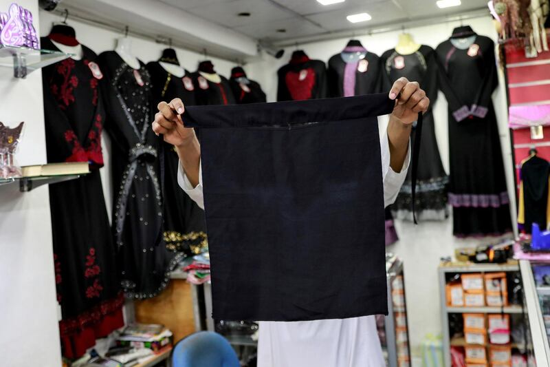 A salesman shows a full face veil, niqab, at a shop selling various kinds of coverings worn by Muslim women in Colombo, Sri Lanka. Reuters