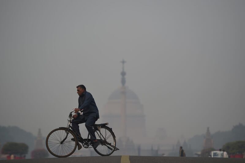 A cyclist rides near the Indian President's house. AFP