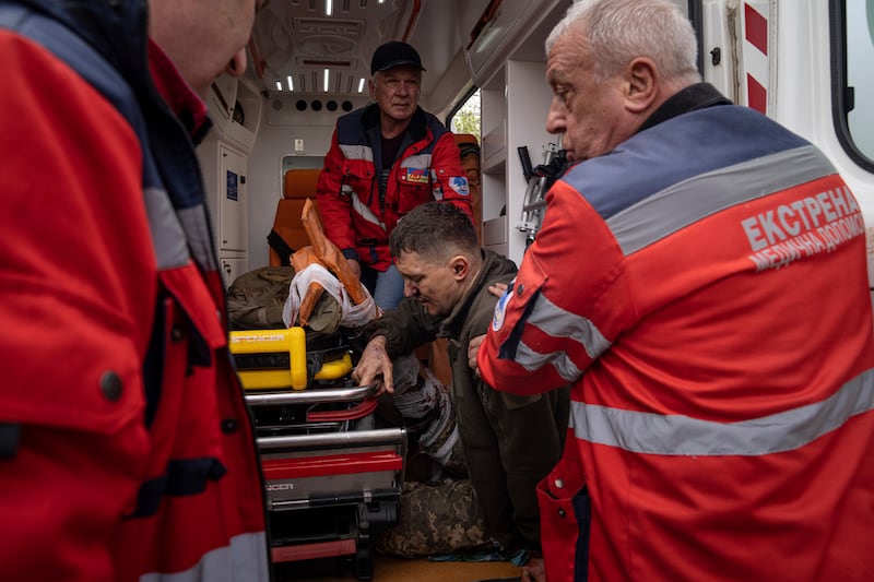 Ambulance workers move an injured Ukrainian serviceman to a hospital in Donetsk. AP