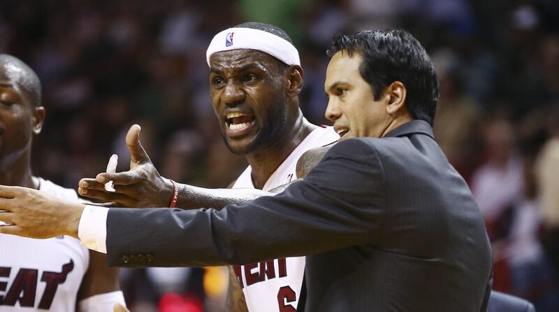 Miami Heat coach Erik Spoelstra, right, and LeBron James protest a loose ball foul called against James against the Los Angeles Clippers last week. J Pat Carter / AP Photo