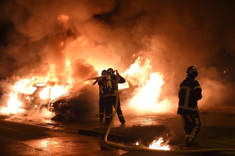 Firefighters work to put out a blaze as cars burn in the Le Breil neighbourhood of Nantes, France, amid ongoing rioting. Guillaume Souvant/AFP