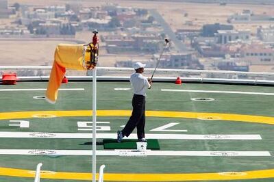DUBAI, UNITED ARAB EMIRATES - MARCH 2:  Tiger Woods of the USA hits balls from the heli-pad on top of the Burj Al Arab Hotel prior to the 2004 Dubai Desert Classic played at the Emirates Golf Club on March 2, 2004 in Dubai, United Arab Emirates.  (Photo by Ross Kinnaird/Getty Images)