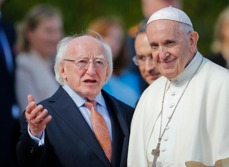 Pope Francis, right, is flanked by Irish President Michael D. Higgins, upon his arrival at the Presidential residence in Dublin, Ireland, Saturday, Aug. 25, 2018. Pope Francis is on a two-day visit to Ireland. (AP Photo/Peter Morrison)