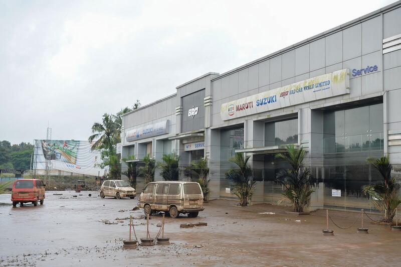 Vehicles lie abandoned at a car showroom and service station after flood waters receded at Chalakudi Taulk in Thrissur District, Kerala. AFP