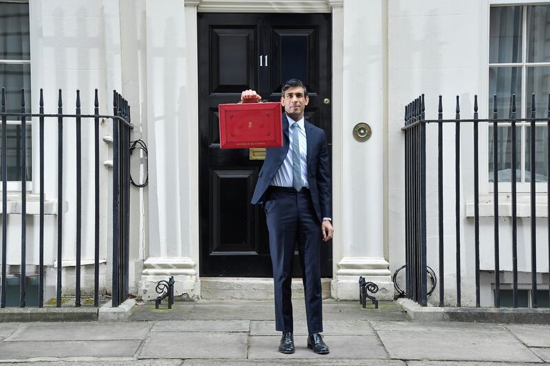 Britain's Chancellor of the Exchequer Rishi Sunak holds the budget box outside Downing Street in London. Reuters