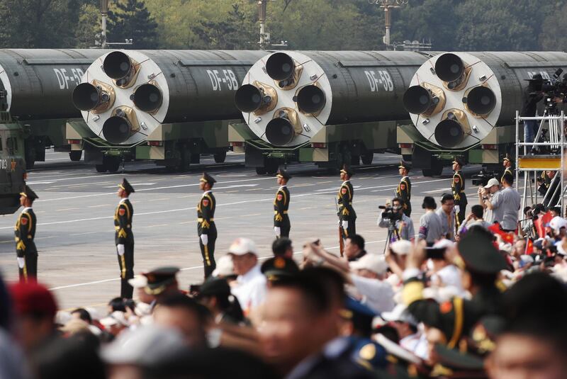 Military vehicles carrying the DF-5B intercontinental ballistic missile  roll past Tiananmen Square. EPA