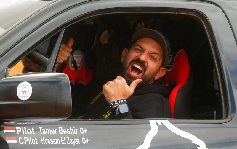 Egyptian driver Tamer Beshir, of Alpha Racing team, gives the thumbs up at the O West Rally 2021. Reuters