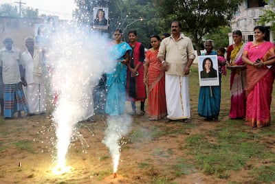 Villagers burst firecrackers to celebrate the victory of U.S. Vice President-elect Kamala Harris in Painganadu a neighboring village of Thulasendrapuram, the hometown of Harris' maternal grandfather, south of Chennai, Tamil Nadu state, India, Sunday, Nov. 8, 2020. Waking up to the news of Kamala Harris' election as Joe Biden's running mate, overjoyed people in her small ancestral Indian village set off firecrackers, carried her placards and offered prayers. (AP Photo/Aijaz Rahi)