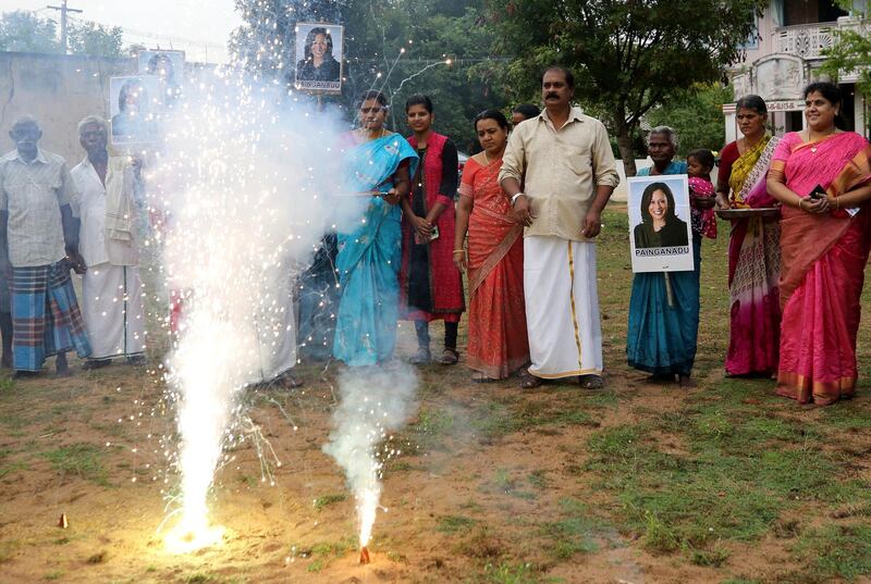 Villagers burst firecrackers to celebrate the victory of U.S. Vice President-elect Kamala Harris in Painganadu a neighboring village of Thulasendrapuram, the hometown of Harris' maternal grandfather, south of Chennai, Tamil Nadu state, India, Sunday, Nov. 8, 2020. Waking up to the news of Kamala Harris' election as Joe Biden's running mate, overjoyed people in her small ancestral Indian village set off firecrackers, carried her placards and offered prayers. (AP Photo/Aijaz Rahi)