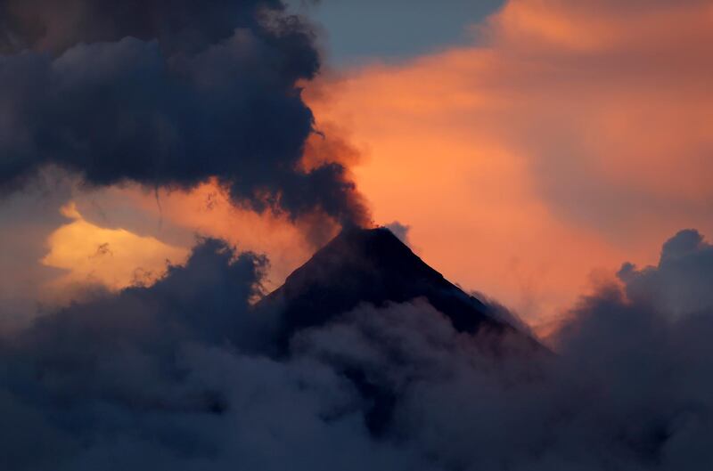 Mayon volcano emits ash during its mild eruption at sunset, as seen from Legazpi city, Albay province around 200 miles southeast of Manila, Philippines. Bullit Marquez / AP Photo