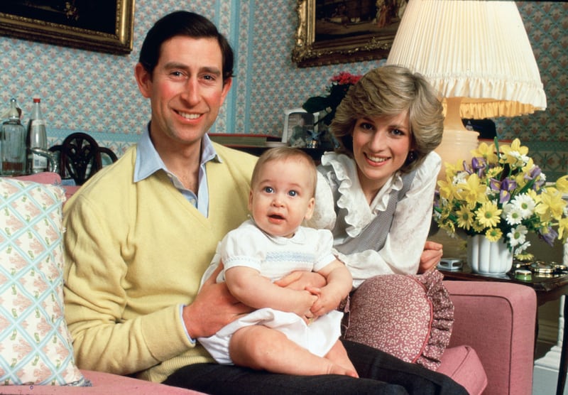 Prince Charles and his wife Diana with their baby son, Prince William, at home in Kensington Palace in 1983 