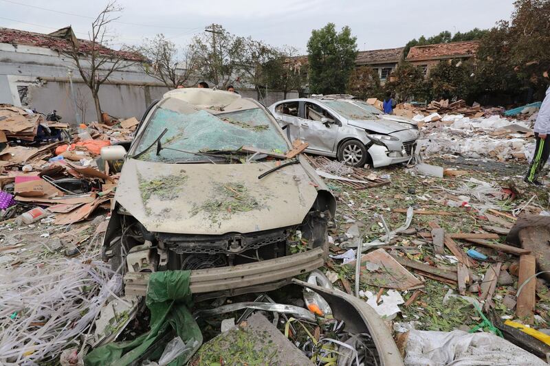 Damaged cars are seen at the site of an explosion in the Chinese megaport city of Ningbo on November 26, 2017. AFP