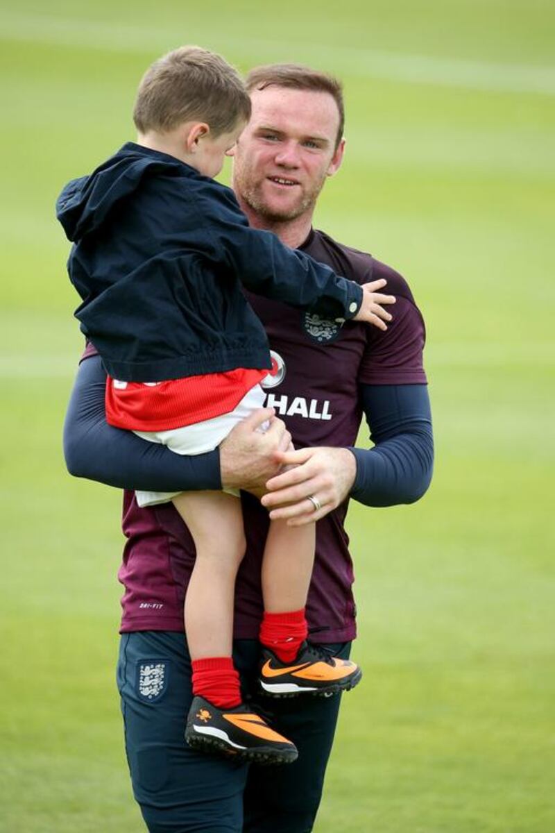 Wayne Rooney hugs his son Kai at the end of England's training session in Portugal on Wednesday for the 2014 World Cup. Richard Heathcote / Getty Images / May 21, 2014