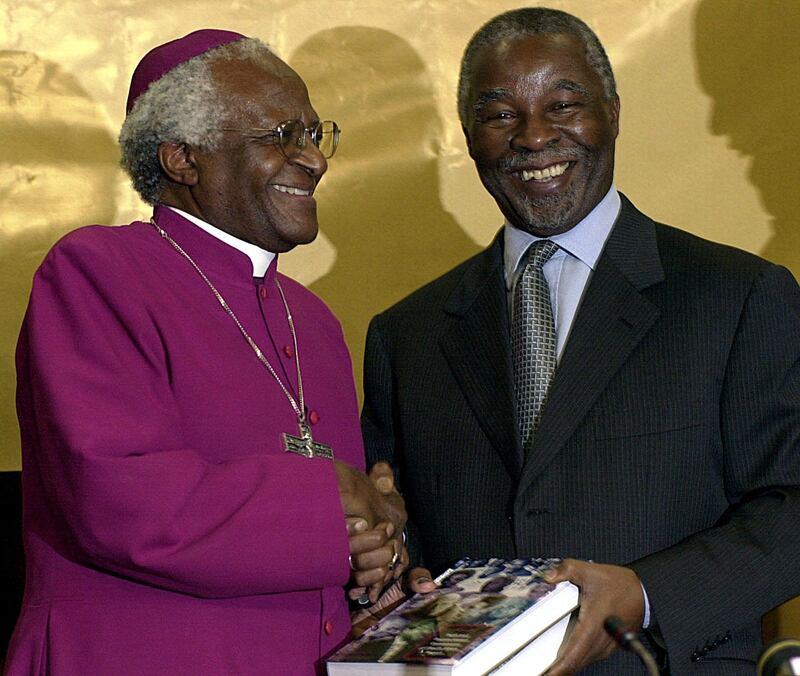 Handing over the Truth and Reconcilliation Report to then South African president Thabo Mbeki, in Pretoria. AFP