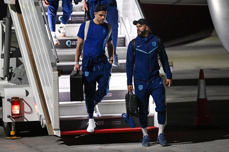 England defender Kyle Walker (R) and midfielder Jack Grealish arrive at the Hamad International Airport in Doha. AFP
