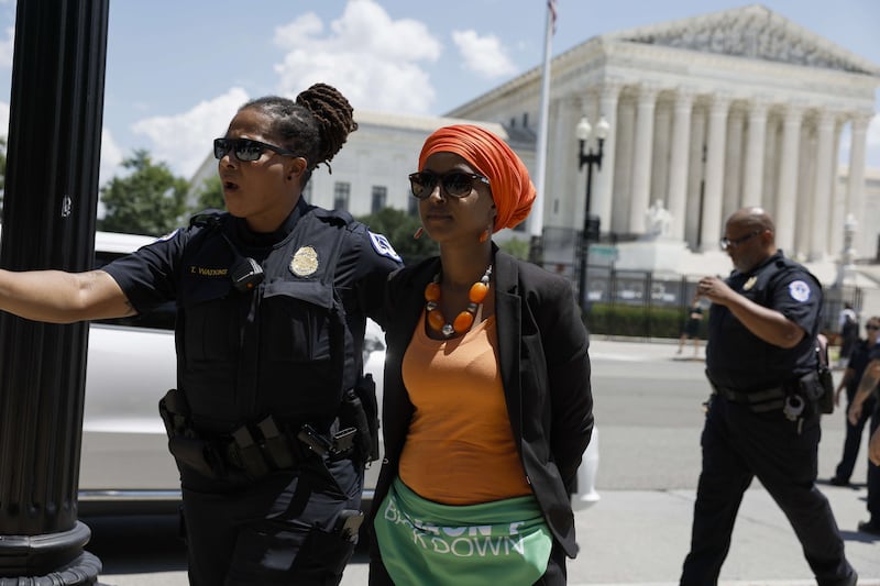 Ilhan Omar is detained by US Capitol police officers after participating in a sit in with activists from the Centre for Popular Democracy Action in front of the Supreme Court Building on July 19. AFP