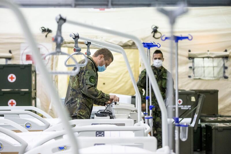 Members of the Czech Army set up equipment and beds inside of field hospital built in an exhibition center in Prague, Czech Republic. Getty Images